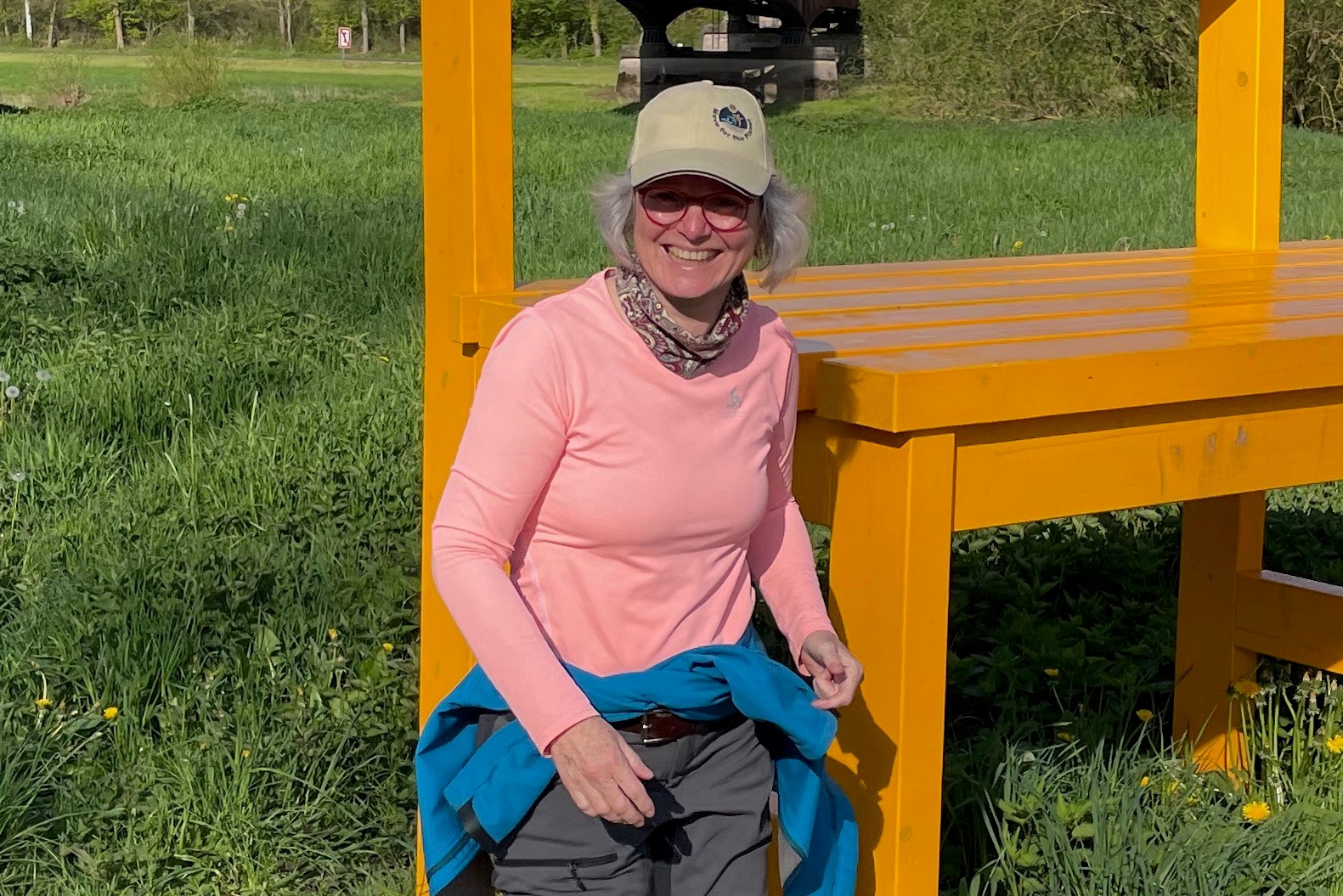 Anja Holtgreve vor einer überdimensionalen Sitzbank im Freien.